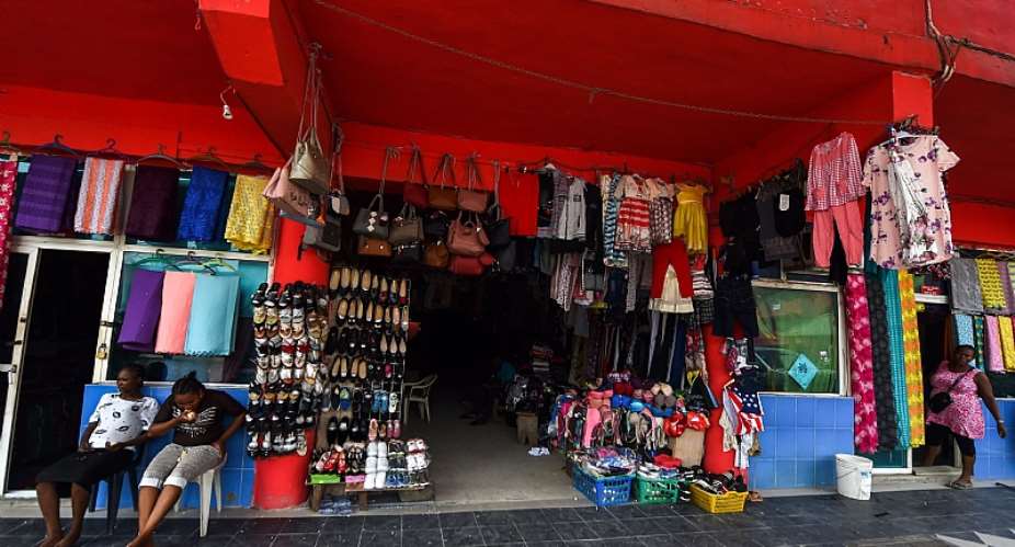 Vendors in front of their shop in China Town, Ojota, Lagos - Source: