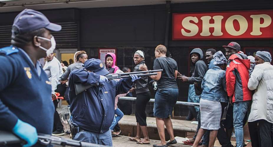 Police trying to enforce  COVID-19 lockdown regulations outside a shop in Yeoville, Johannesburg. - Source: Marco LongariGettyImages