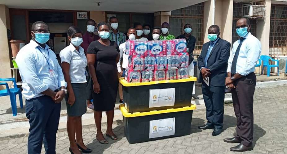 Officials Of Mamprobi Polyclinic With Specialist Doctor In Charge Of The Mamprobi Polyclinic, Dr. Charlotte-Alberta Baaba Cato Third Left Receiving The Package