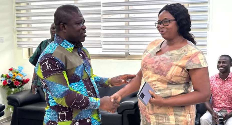 Volta Regional Min. Hon. James Gunu exchanging handshakes with the Volta Regional Director of ECG, Ms. Christina Jatoe-Kaleo.