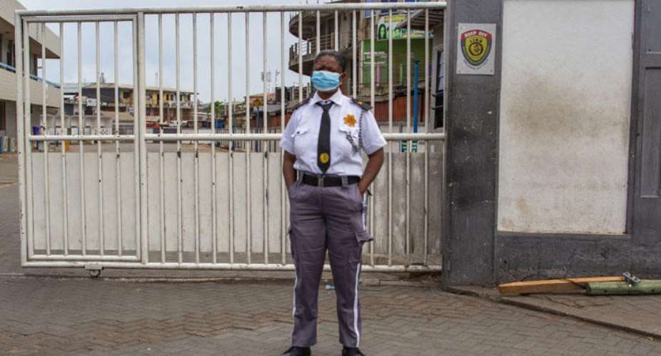 A security guard wears a mask as a protective measure against COVID-19 disease in Accra, Ghana, on April 4, 2020. Soldiers enforcing restrictions related to the pandemic assaulted journalists in two separate incidents. Nipah DennisAFP