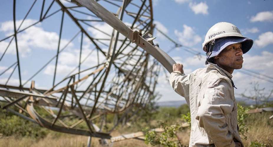 A worker leans on a collapsed pylon in Pretoria on April 12, 2023. Ageing infrastructure exacerbates the country's energy supply crisis.  - Source: Michele Spatari/AFP via Getty Images