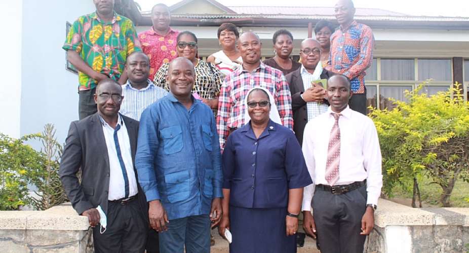 Dr. Ahmed Jinapor 2nd left in a group picture with stakeholders after the meeting at Holy Child College of Education