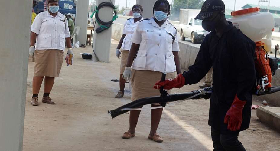 Health workers fumigate Lagos streets during the COVID-19 lockdown in Nigeria.  - Source: Photo by Adekunle AjayiNurPhoto via Getty Images