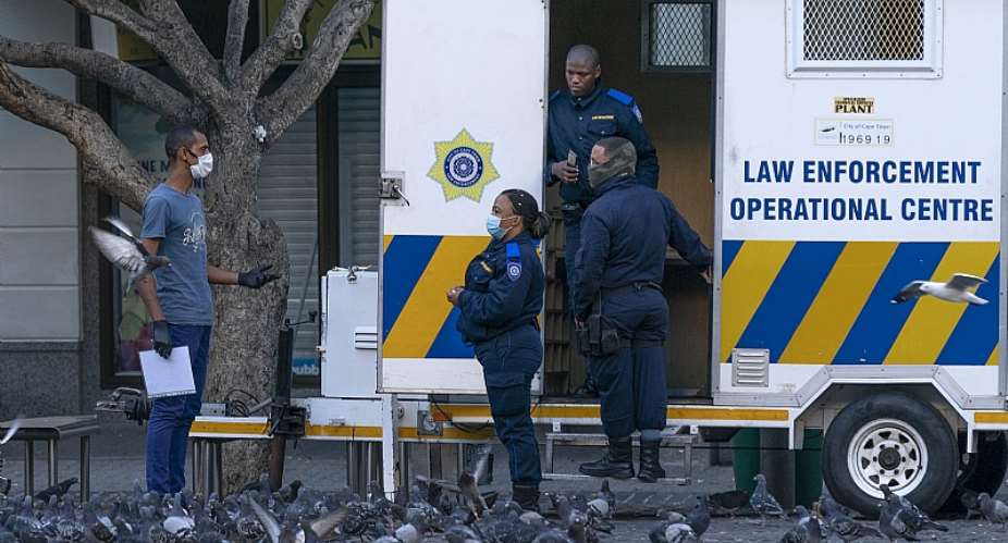South African Law Enforcement officers check movement papers during the countryamp;39;s 21-day national total lockdown. - Source: Nic BothmaEPA