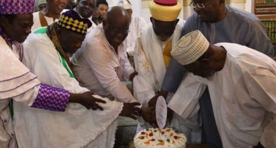 The cleric being assisted to cut the birthday cake