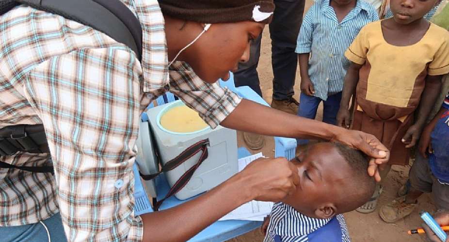 A child taking the oral polio vaccine