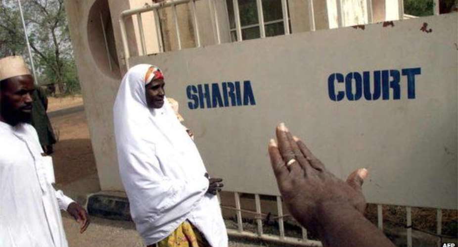A woman arrives at the Sokoto State Sharia Court of Appeal in Sokoto