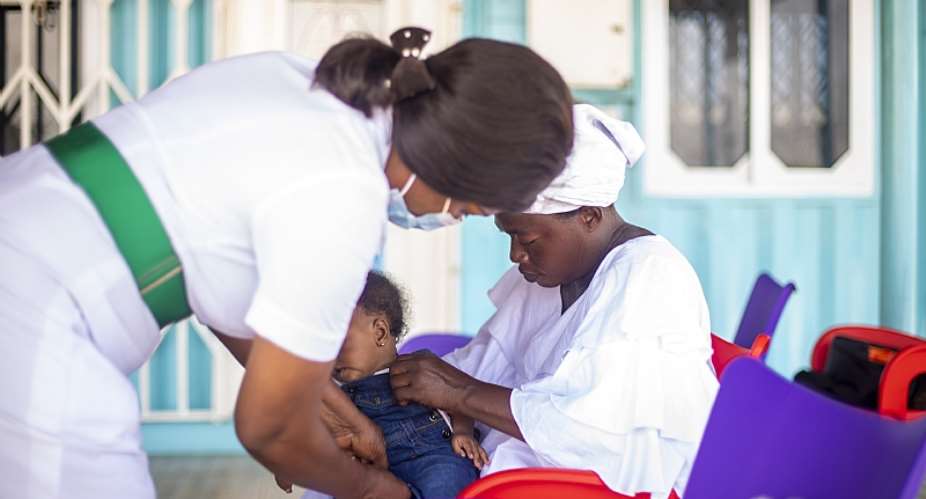 A photo of a nurse attending to Deborah otoo- A beneficiary from one of the CHPS Compound donated by UNDP and partners