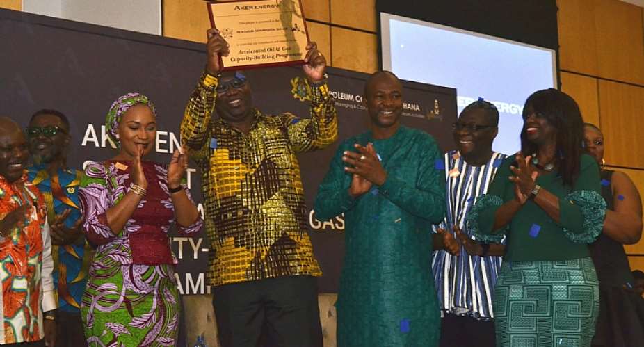 Mr. Egbert Faibille Jnr. Acting CEO of Petroleum Commission displays the plaque symbolising the commencement of Aker Energys support for the AOGC Programme at the Announcement ceremony as Her Excellency Hajia Samira Bawumia Deputy Energy Minister and some Board members look on