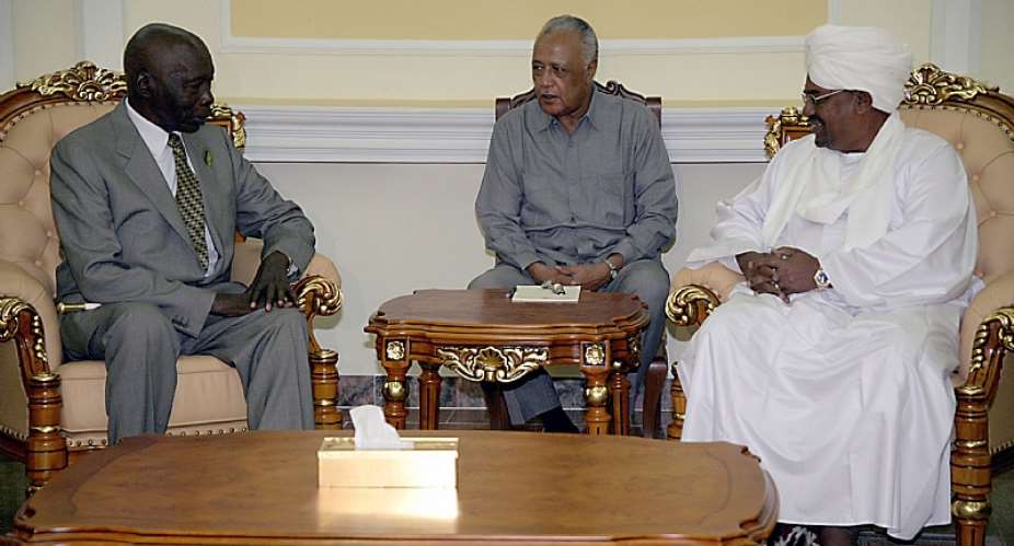 Former Kenyan President Daniel arap Moi left during peace talks with Former Sudanese President Omar al-Bashir right in Khartoum in 2007. Between them is an interpreter.  - Source: Philip DhilEPA