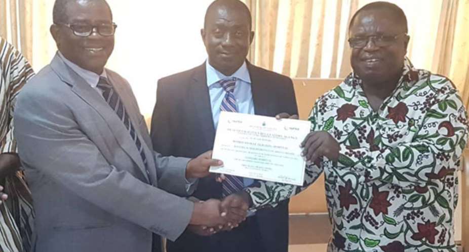 Dr. Oheneba Danso middle receiving the HeFRA certificate from Nana Otuo Acheampong