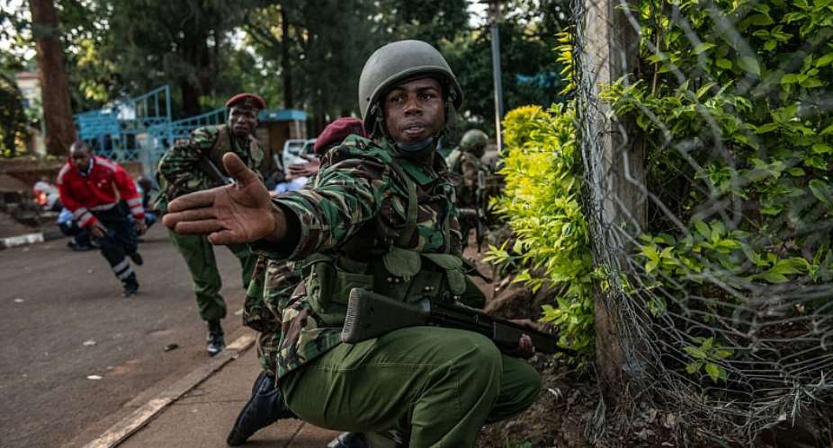 A Kenyan soldier urges people to take cover during the terror attack on the Dusit Hotel complex in 2018. - Source: Andrew RenneisenGettyImages