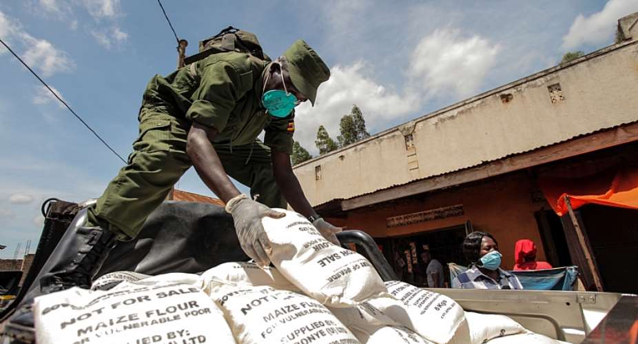 A military officer distributes maize flour in Kampala, Uganda, where the urban poor have been affected by the lockdown.  - Source: Hajarah NalwaddaXinhua via GettyImages