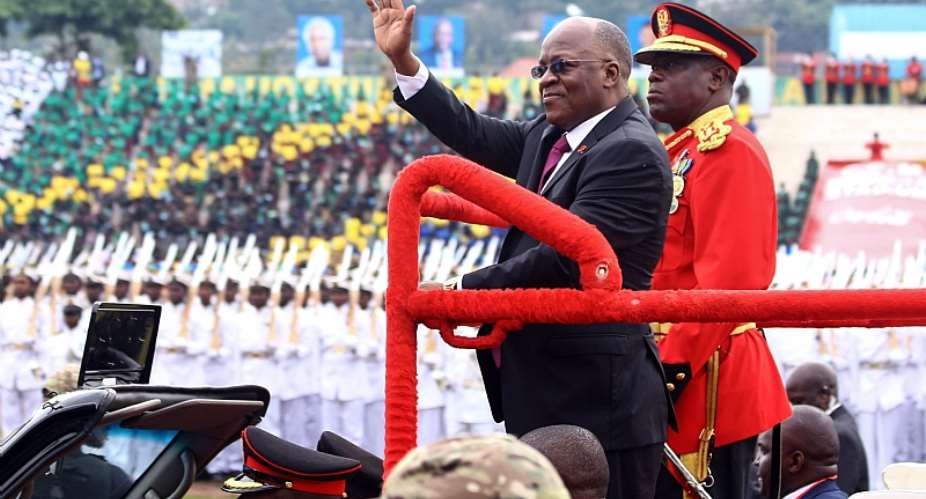 Tanzanian President John Magufuli waves as he attends a ceremony marking the countryamp;39;s 58th independence anniversary in 2019. - Source: StringerAFP via GettyImages