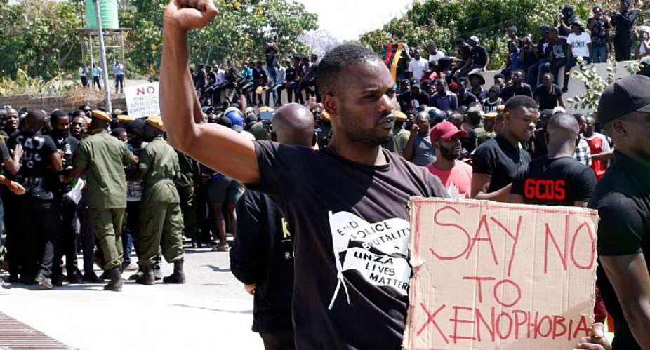 A protestor gestures and holds a placard during a demonstration in front of the South African Embassy in Lusaka, Zambia on September 4, 2019 (Source: CNN)