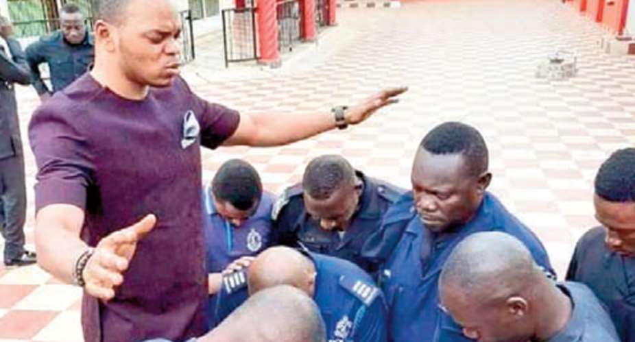 Daniel Obinim praying for some police officers