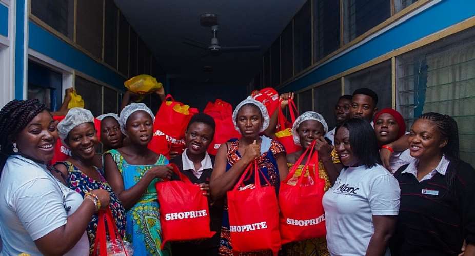 Image description: The Executive Director of AFPNC right together with some mothers and officials of  Shoprite Ghana Ltd and the Effia-Nkwanta Hospital.