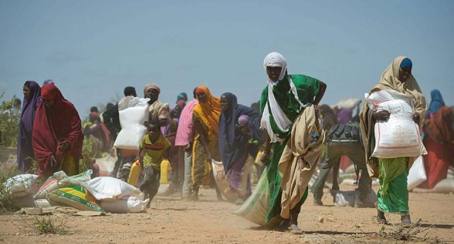 Women receive food aid in Somalia. Terrorism creates food disruptions, undermining production systems and supply routes. - Source: Tobin Jones/Wikimedia Commons