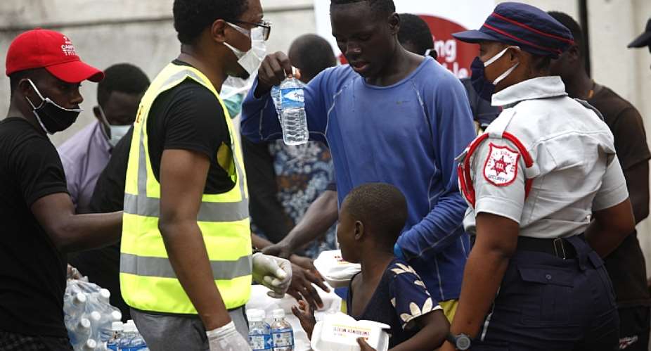People receiving food handouts in Lagos, Nigeria. - Source: AAP