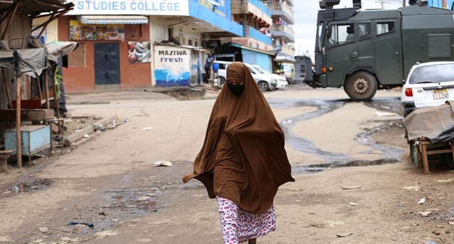 A woman walks past a police armed vehicle in Eastleigh - Nairobiamp;39;s amp;quot;little Mogadishuamp;quot; - Source: Photo by Billy MutaiSOPA ImagesLightRocket via Getty Images