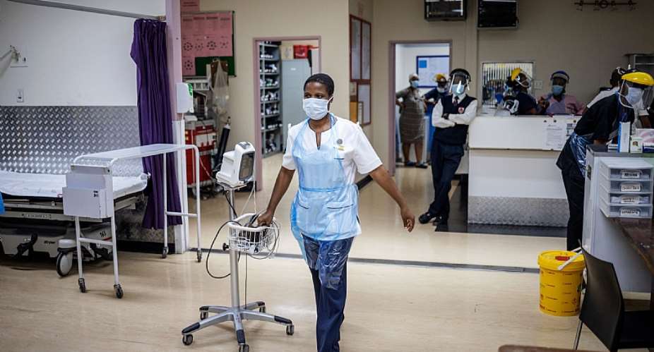 A health worker drags an electrocardiograph at the Charlotte Maxeke Hospital in Johannesburg.  - Source: Michele SpatariIAFP via Getty Images