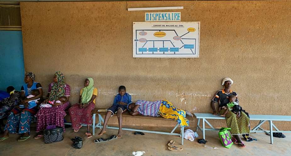 Women and children wait to be treated at a health clinic in northern Burkina Faso.  - Source: Giles Clarke/UNOCHA via Getty Images