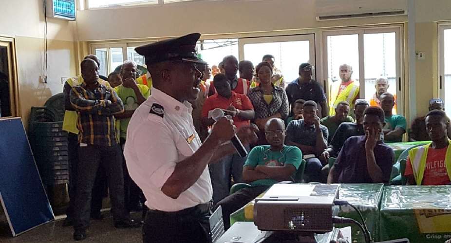 Osmond Annum explaining a point to some staff of ABL