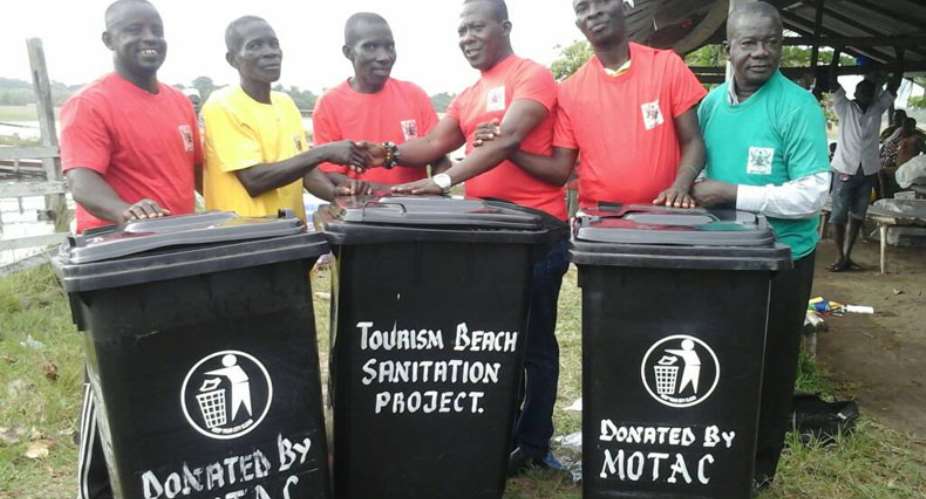 Nana Anim 3rd from right presenting the dust bins to the people of Nzulenzo