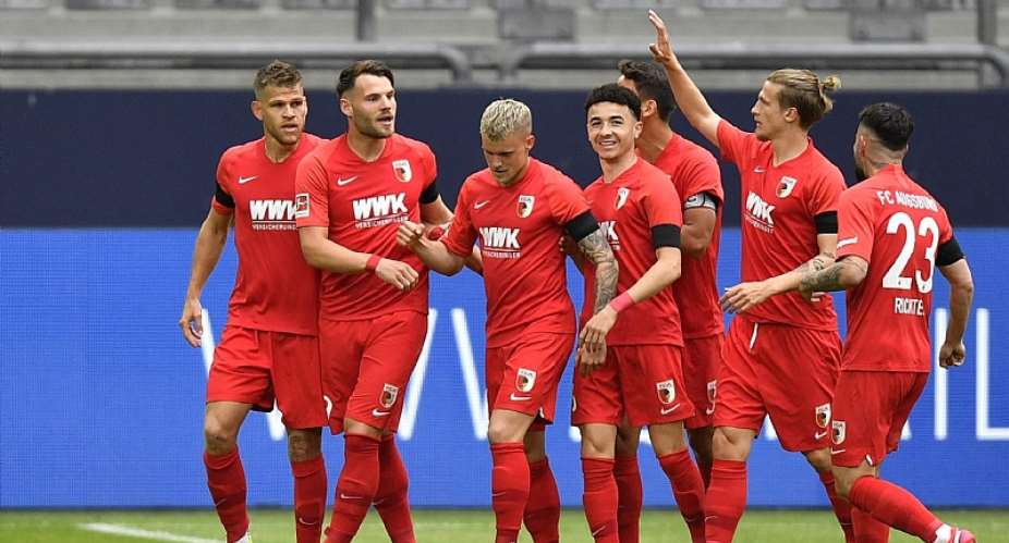 Eduard Loewen of Augsburg celebrates with teammates after scoring their sides first goal during the Bundesliga match between FC Schalke 04 and FC Augsburg at Veltins-Arena on May 24, 2020 in Gelsenkirchen, Germany.Image credit: Getty Images
