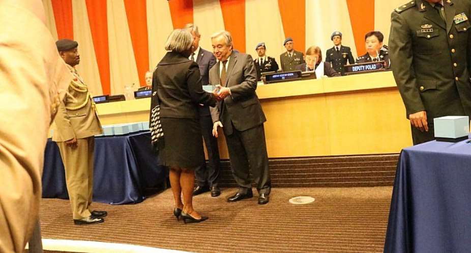 Picture by R. Harry Reynolds shows Ambassador Pobee receiving the medals from the Secretary General Antonio. Behind her is Brig. Reginald Odoi, Military Advisor