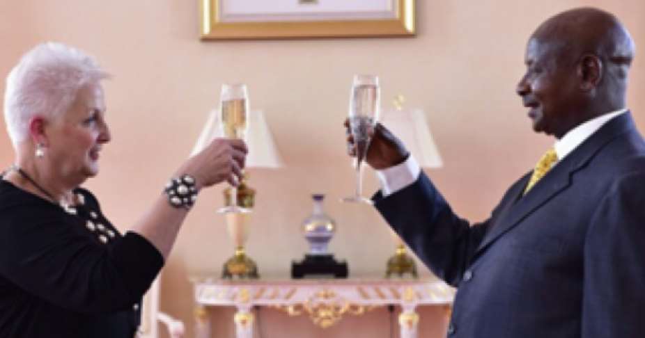 Champagne toast. U.S. Ambassador to Uganda Deborah Malac and dictator Museveni. This is when she presented her credentials to Museveni in 2015 as reported in The New Vision. Photo: Uganda's Presidential Press Unit.