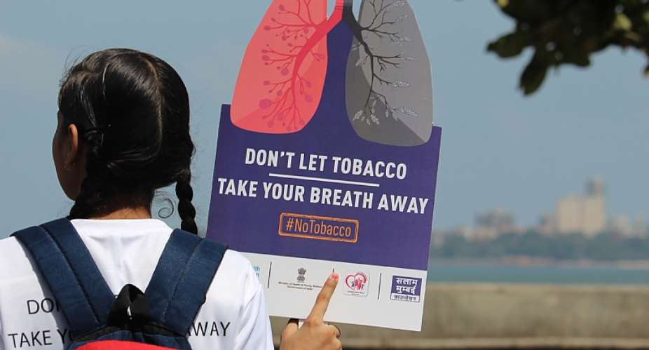A girl holds a placard during a rally to create awareness about the effect of tobacco. - Source: Himanshu BhattNurPhoto via Getty Images