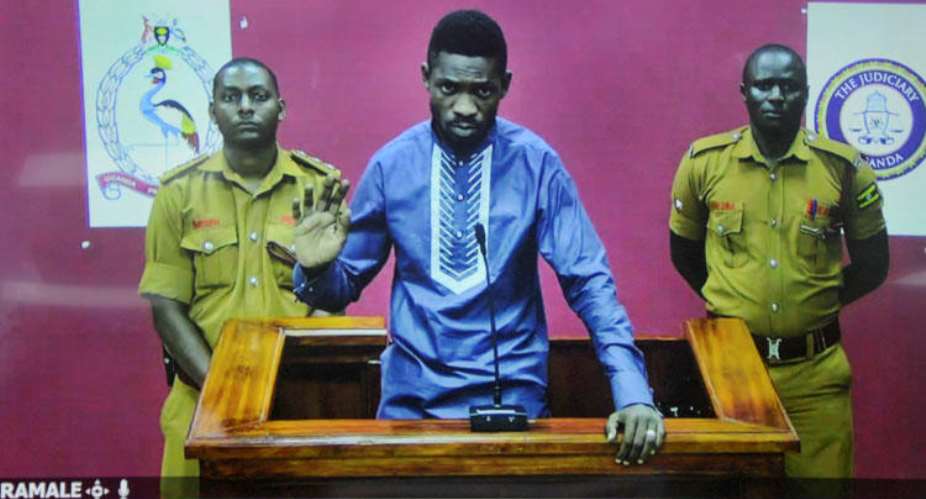 Ugandan pop star and opposition figure Bobi Wine appears for his bail application via a video link from prison, on a television screen in a court in Kampala, Uganda, on May 2, 2019. Uganda's media regulator suspended staff from 13 broadcast outlets for covering his arrest. APRonald Kabuubi