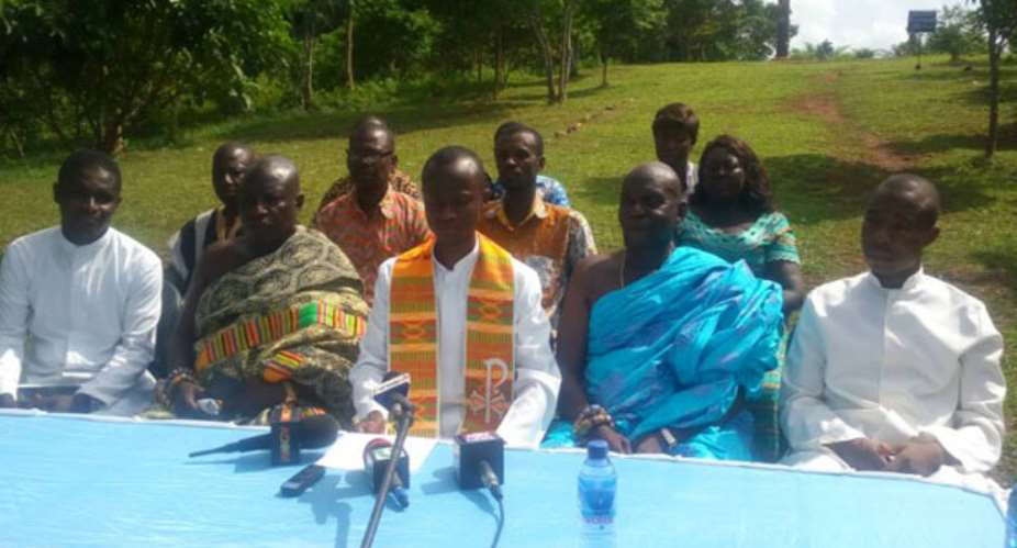 Rev Fr Paintsil addressing the media as other church members look on