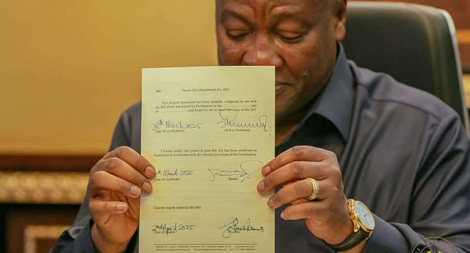 President Mahama signing bills into law