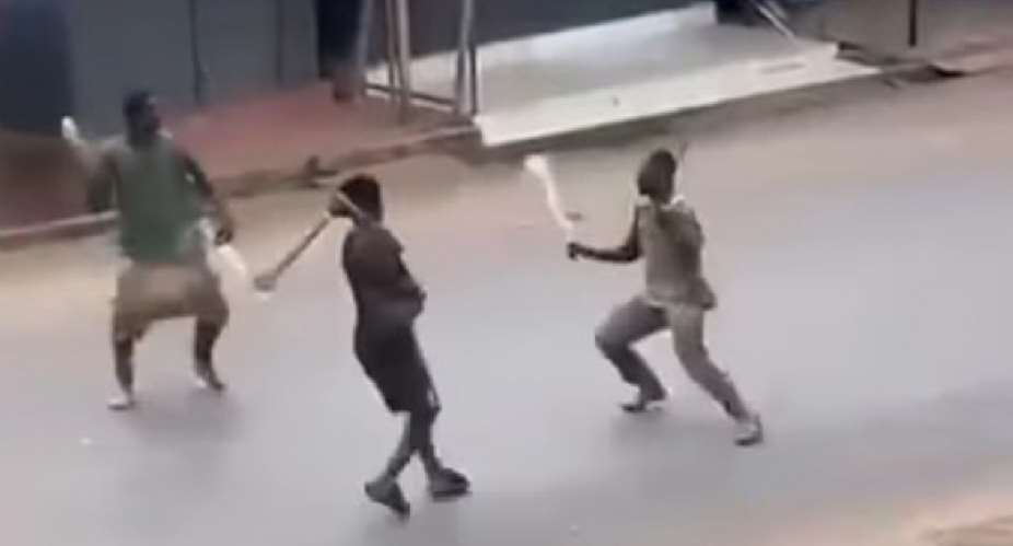 3 young guys engaging in machete fight