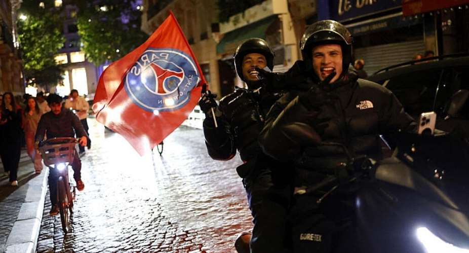 PSG supporters celebrate near the Champs-lyses in Paris after the club reached the UEFA Champions League final on 6 May. - AFP - SIMON WOHLFAHRT