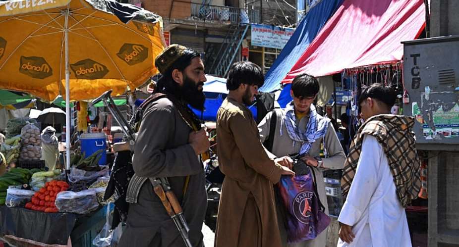 An armed Taliban security personnel walks through a marketplace in Asadabad, Kunar province, Afghanistan, on June 10, 2026. -  Wakil Kohsar, AFP