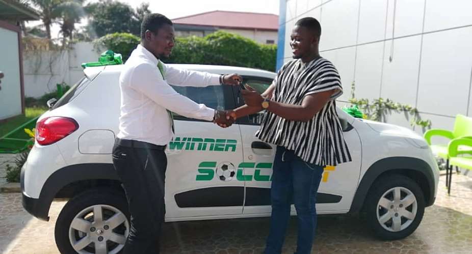 Mr. Kpiasi Sulley Batong receiving his brand new Renault KWID from SoccaBet