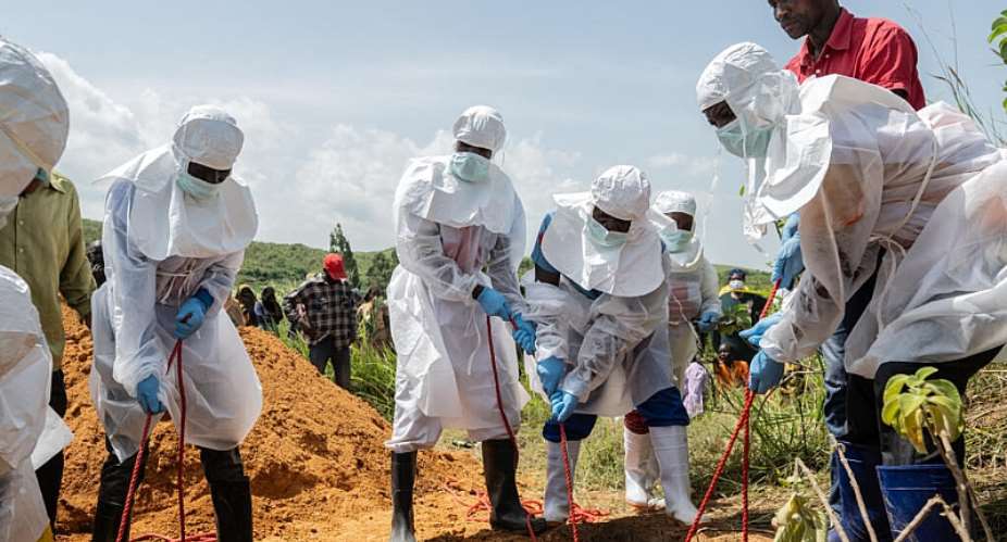 Red Cross workers bury an Ebola victim at the Rwampara Cemetery, in Rwampara, DR Congo, May 23, 2026. -  Moses Sawasawa, AP