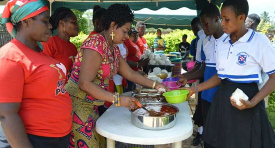 Queenstar Pokuah Sawyeer second left serving meals to the candidates