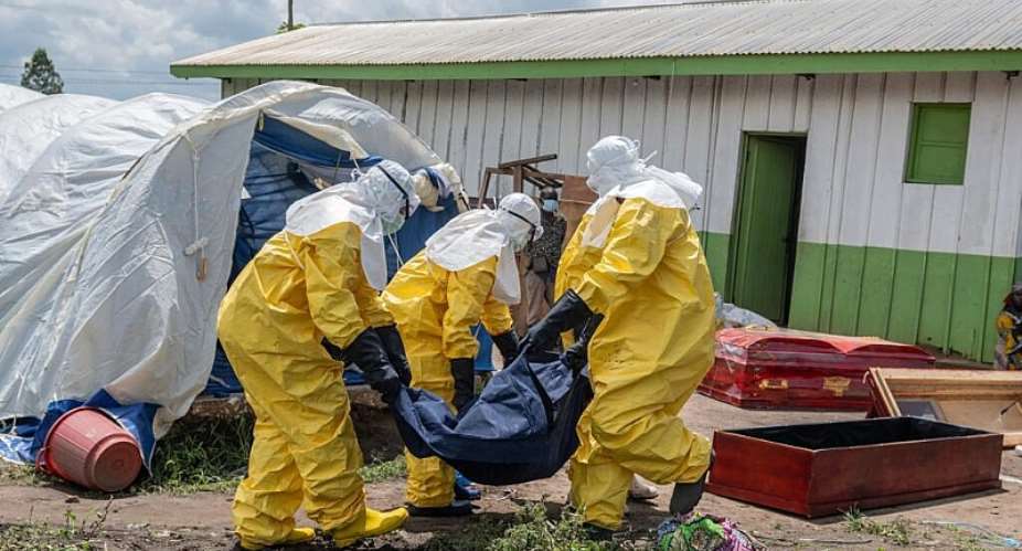 Red Cross workers carry the body of a person who died of Ebola into a coffin at a health centre in Rwampara, Ituri Province, DR Congo, Wednesday, 20 May 2026. -  AP Photo/Moses Sawasawa