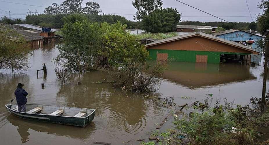 (FILE) A man paddles a boat along a flooded street in the Harmonia neighborhood in the city of Canoas, Rio Grande do Sul state, Brazil, on May 13, 2024. -  Nelson Almeida, AFP
