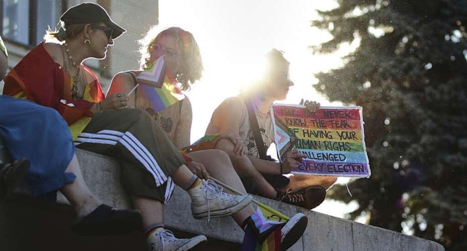 People hold signs during the Pride march in Budapest on June 28, 2025. -  Rudolf Karancsi, AP