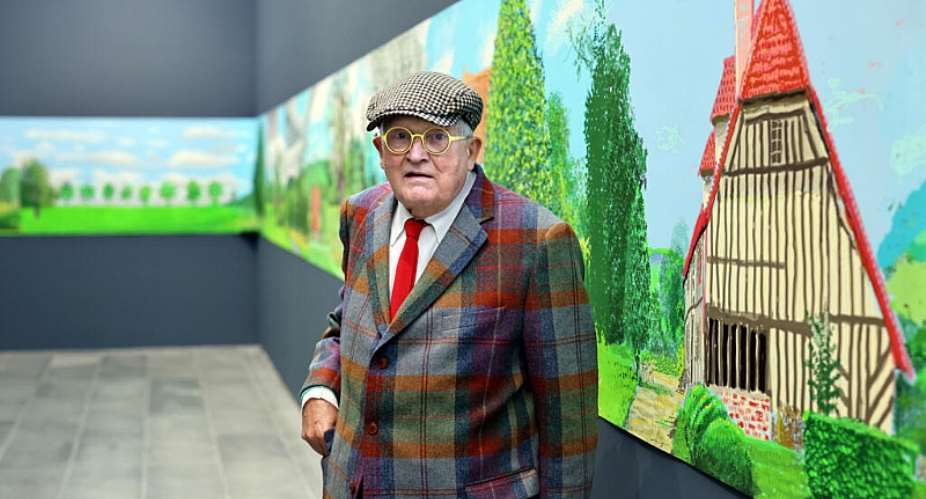 Late British painter David Hockney poses at the Orangerie museum in Paris, on October 7, 2021, in front of his painting A year in Normandy. -  Thomas Coex, AFP