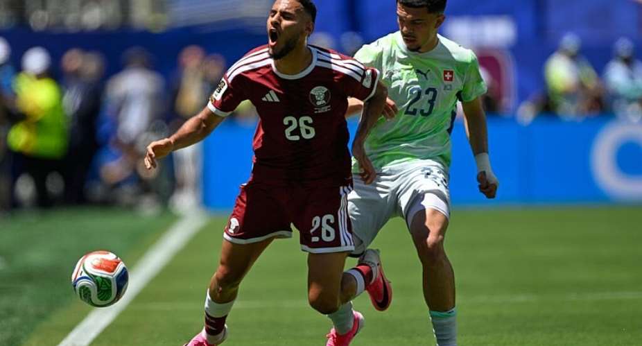 Qatars Mohamed Manai left, falls under pressure from Switzerlands Zeki Amdouni during the World Cup Group B soccer match between Qatar and Switzerland in Santa Clara, Calif., near San Francisco, Saturday, June 13, 2026. -  Eakin Howard, AP