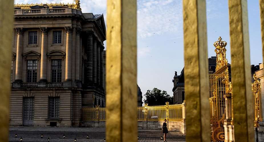 A worker greets guests for an event on the grounds of the Chateau de Versailles on Friday, Aug. 2, 2024, in Versailles, France. -  David Goldman, AP