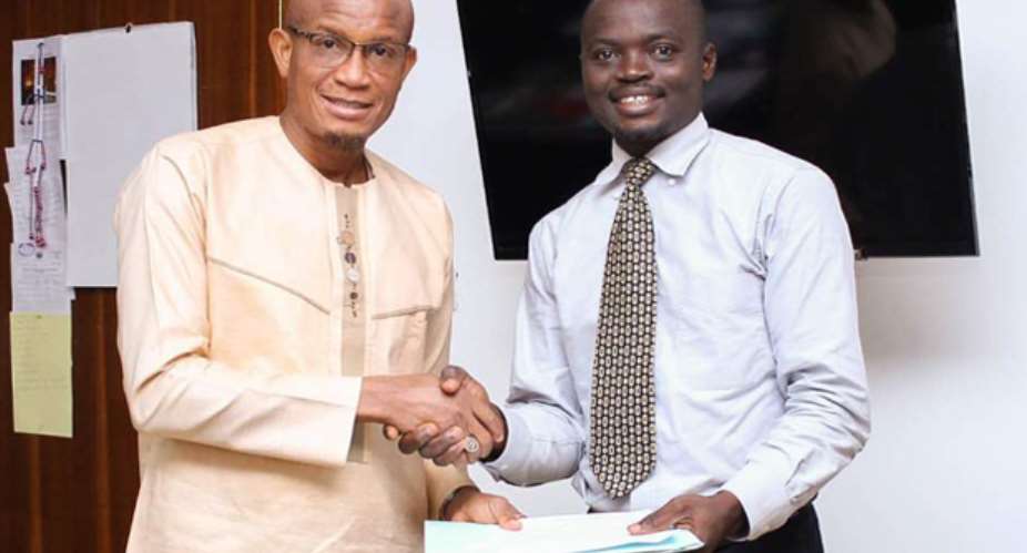 Mustapha Hamid (left) receiving the petition from James Oberko