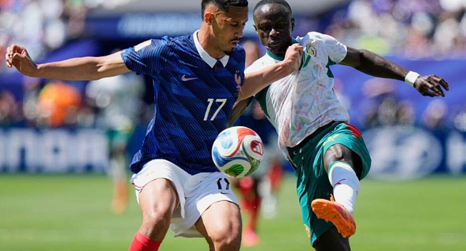 Frances William Saliba (17) and Senegals Sadio Mane (10) battle for the ball during the World Cup Group I soccer match between France and Senegal. -   AP Photo/Steve Luciano